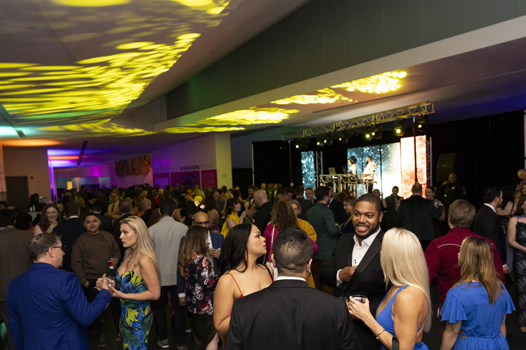 A large room is packed with well-dressed guests for Party Arty: Painted Night.